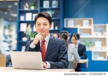 Middle-aged businessman working in the office Middle-aged businessman working in the office 134584614
