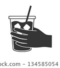 Silhouette icon of a hand holding iced coffee 134585054