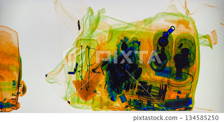 X ray view of colorful baggage at security checkpoint showing bags and travel items 134585250