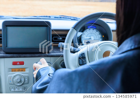 畫面中一位二十多歲的女性正在開車(沒有露臉)。 畫面中一位二十多歲的女性正在開車(沒有露臉)。 134585971