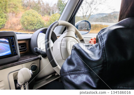 A scene of a woman in her 20s driving a car (no face) A scene of a woman in her 20s driving a car (no face) 134586016