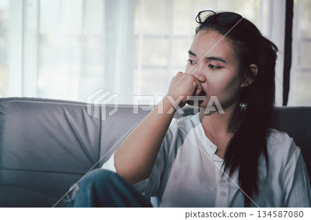Sorrowful woman sat alone, overwhelmed by emotion, her sad and unhappy expression revealing deep despair, stress and distress left feeling depressed. sorrowful sad, despair alone, depressed stress Sorrowful woman sat alone, overwhelmed by emotion, her sad and unhappy expression revealing deep despair, stress and distress left feeling depressed. sorrowful sad, despair alone, depressed stress 134587080