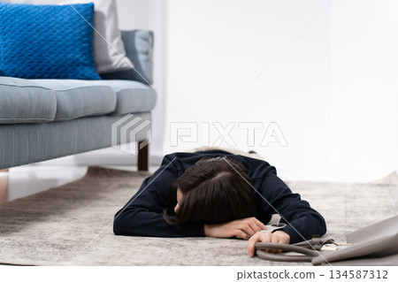 A woman falls down while holding a smartphone A woman falls down while holding a smartphone 134587312