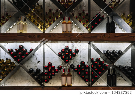 Modern Wine Cellar Display with Wooden Grid and Backlighting Modern Wine Cellar Display with Wooden Grid and Backlighting 134587592