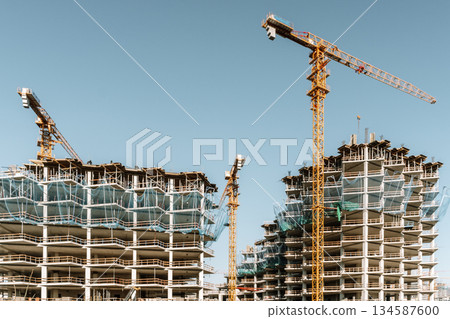 Construction of a building. Construction site with crane. Business, development, industry. Construction of a building. Construction site with crane. Business, development, industry. 134587600