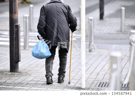 Yokohama cityscape in Japan. Obstacles and safety... Aging society... Elderly woman with a walking stick... Cold weather on the winter solstice... 134587941