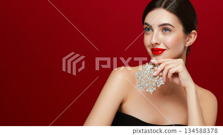 Beautiful young woman with glowing snowflake 134588378