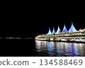 Illuminated port facilities and the night view reflected on the water 134588469