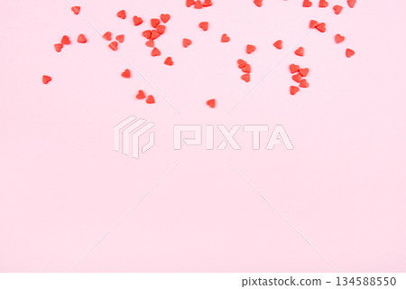 Tiny red hearts on pink background. Valentine's day concept. Top view. Tiny red hearts on pink background. Valentine's day concept. Top view. 134588550