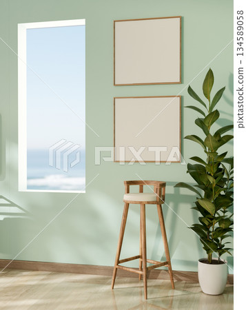 Wooden stool chair under blank photo frame near rectangular hole in green mint wall along a corridor 134589058