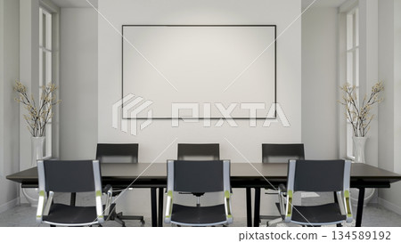 Blank frame or white board or a screen hanging on wall over a long black table and swivel chairs in meeting room 134589192
