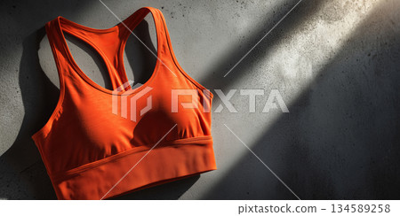 Vibrant orange activewear flatlay inviting workout inspiration and energy 134589258