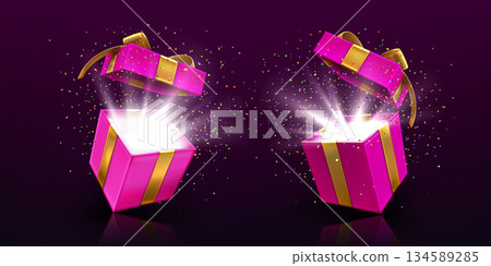 Open gift boxes with light and confetti on black Open gift boxes with light and confetti on black 134589285