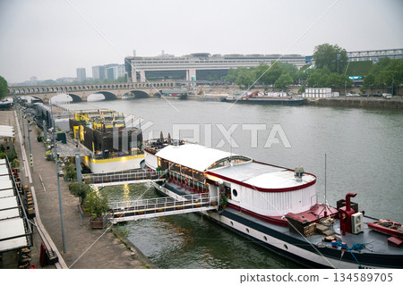Morning on Seine riverbank embankmenrt- ship moored on right riverbank early at morning in springtime (May) Morning on Seine riverbank embankmenrt- ship moored on right riverbank early at morning in springtime (May) 134589705