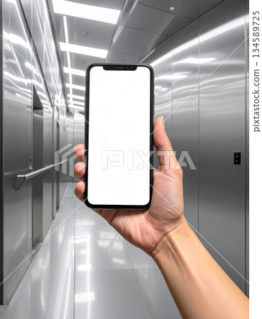 Hand Displaying Phone in Sleek, Reflective Elevator Interior 134589725