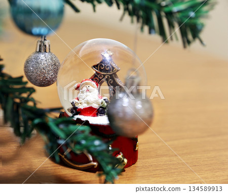 Still life Christmas St.Nicolas (toy) with snow an Christmas decoration and pomegranate seeds 134589913