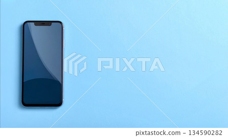 Smartphone and copy space placed on a light blue background. Simple and refreshing smartphone image. 134590282