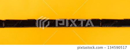 Macro of RAM gold contacts on bright yellow background Macro of RAM gold contacts on bright yellow background 134590517