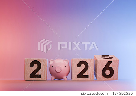 Financial plan for 2026. A small piggy bank standing between wooden blocks displaying the date. Concept for savings, investment, budget planning, and New Year financial goals. 2026 financial concept Financial plan for 2026. A small piggy bank standing between wooden blocks displaying the date. Concept for savings, investment, budget planning, and New Year financial goals. 2026 financial concept 134592559