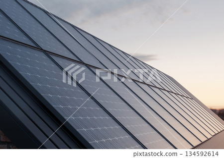 Solar panels on a rooftop capturing sunlight at sunset, symbolizing clean renewable energy, sustainability, and modern eco-friendly home power solutions. Solar panels on a rooftop capturing sunlight at sunset, symbolizing clean renewable energy, sustainability, and modern eco-friendly home power solutions. 134592614