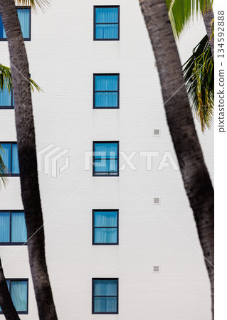 Rows of square windows in a white-walled building 134592888