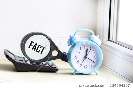 Fact Business Marketing Strategy is a text word written on a magnifying glass 134594507