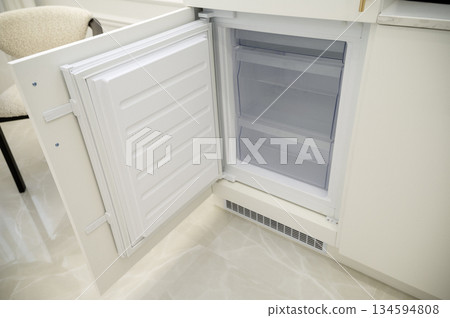 open refrigerator freezer door, empty and clean. Empty built-in refrigerator after cleaning 134594808