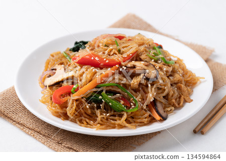 Japchae, Korean stir fried glass noodles with vegetables, pork, soy sauce and sesame oil Japchae, Korean stir fried glass noodles with vegetables, pork, soy sauce and sesame oil 134594864
