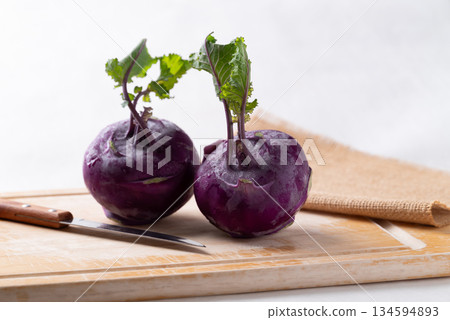 Purple kohlrabi or turnip cabbage on cutting wooden board Purple kohlrabi or turnip cabbage on cutting wooden board 134594893