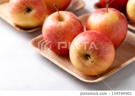 Red apple fruit (Gala apple) in natural plate on white background 134594902