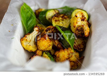 Delicious vegetarian baked vegetables with herbs and olive oil Delicious vegetarian baked vegetables with herbs and olive oil 134595269