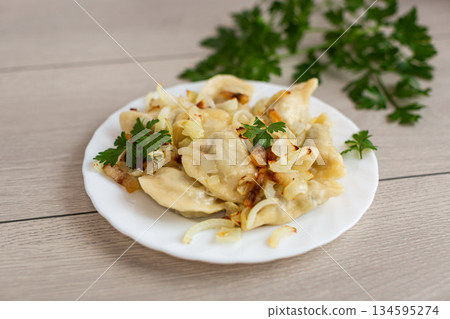 Ukrainian dumplings with potato filling and caramelized onions 134595274
