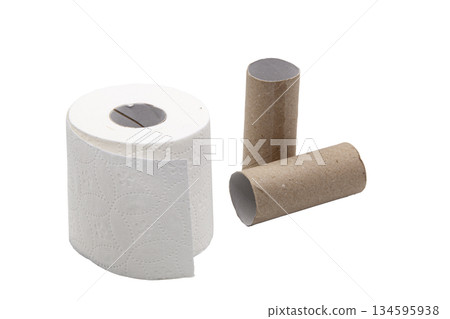 A soft roll of toilet paper with an embossed pattern next to two brown cardboard tubes. Concept of household, consumption, personal hygiene, and paper recycling. 134595938