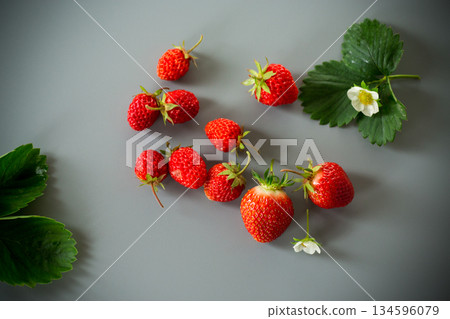Ripe red strawberries on a gray background from above 134596079