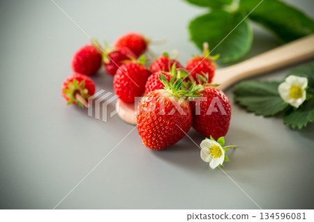 Bright ripe strawberries on a neutral gray surface Bright ripe strawberries on a neutral gray surface 134596081
