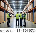 Workers carrying goods at a logistics warehouse 134596973
