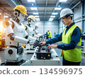 Workers working alongside humanoid robots 134596975