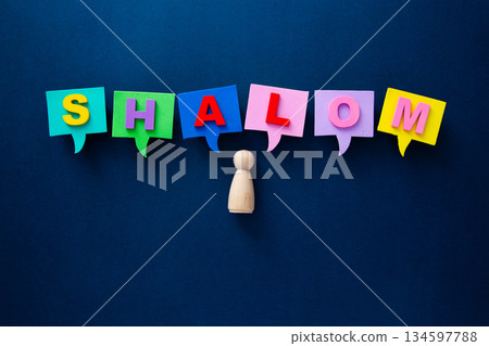Wooden person expressing shalom word in colorful speech bubbles Wooden person expressing shalom word in colorful speech bubbles 134597788