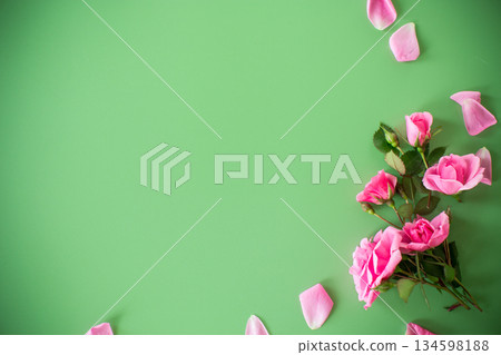 Top view of branches of roses on a green background Top view of branches of roses on a green background 134598188