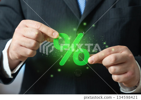 Green percentage in the businessmans hands. Financial benefits and banking opportunities. Investment, personal finance and loan. Attractive interest rates on deposits and favorable loan terms. 134598421