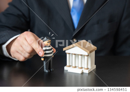 The bank and the bank robber. Keep your savings safe. Prevent money laundering. Financial crime prevention concept, banking security systems. Protection of deposits, compliance measures. The bank and the bank robber. Keep your savings safe. Prevent money laundering. Financial crime prevention concept, banking security systems. Protection of deposits, compliance measures. 134598451