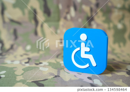 Symbol of a person with a disability on a military background. Support for veterans and military personnel with limited mobility. Assignment of disability status. Benefits and compensation. Symbol of a person with a disability on a military background. Support for veterans and military personnel with limited mobility. Assignment of disability status. Benefits and compensation. 134598464