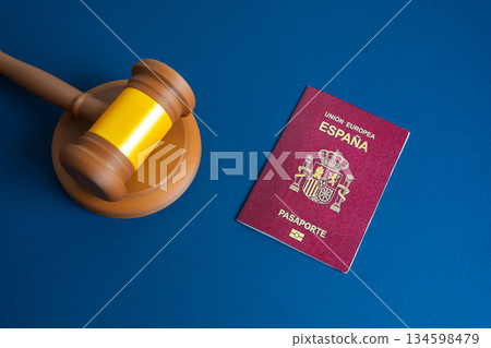 Spanish passport near judge's gavel. Court and protection of the rights of citizens. Visa regulation, and migration law enforcement. Citizenship and right of residence. Spanish passport near judge's gavel. Court and protection of the rights of citizens. Visa regulation, and migration law enforcement. Citizenship and right of residence. 134598479
