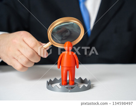 A businessman baited a trap in the form of a red man figurine. Candidates with poor backgrounds and security risks. Recruitment screening, threat detection. Corporate safety awareness. 134598497