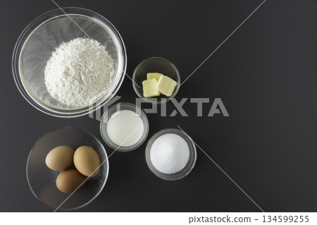 Ingredients for making sponge cake: flour, eggs, sugar, butter, milk, bird's-eye view, margin Ingredients for making sponge cake: flour, eggs, sugar, butter, milk, bird's-eye view, margin 134599255