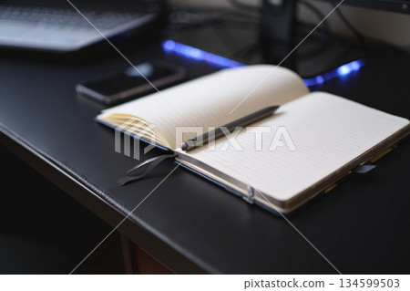 notebook, pen, notebook, pen and notebook on table 134599503