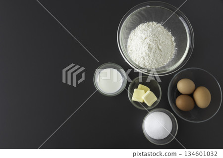 Ingredients for making sponge cake: flour, eggs, sugar, butter, milk, bird's-eye view, margin, horizontal Ingredients for making sponge cake: flour, eggs, sugar, butter, milk, bird's-eye view, margin, horizontal 134601032