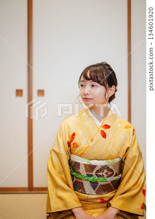 A beautiful young kimono woman posing in a Japanese-style room A beautiful young kimono woman posing in a Japanese-style room 134601920