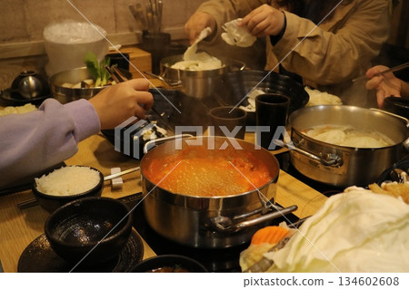 People enjoyed hot pot together. People enjoyed hot pot together. 134602608