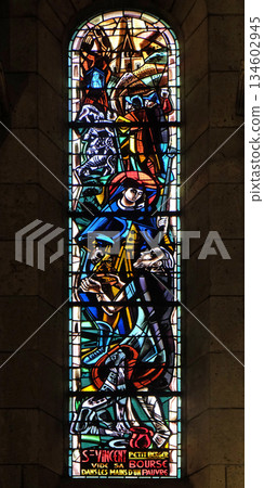St Vincent empties his purse in the hands of a poor, stained glass window in Basilica of the Sacre Coeur, dedicated to the Sacred Heart of Jesus in Paris 134602945